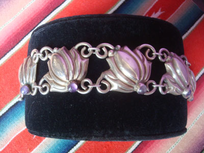 Mexican vintaage sterling silver jewelry, and Taxco vintage sterling silver jewelry, a beautiful sterling silver bracelet with floral pendants and cabochons of amethyst, Taxco, c. 1940. The silverwork is exceptional, and the bracelet is graceful and elegant. Another side view of the bracelet.
