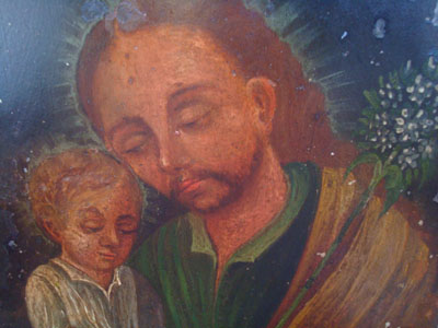 Mexican vintage devotional art, a retablo painted on tin depicting St. Joseph with the baby Jesus, c. 1920.