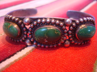 Native American Indian sterling silver jewelry, and Navajo vintage sterling silver jewelry, a beautiful Fred Harvey silver bracelet with wonderful stamping and lovely turquoise stones each showing a beautiful matrix, Arizona or New Mexico, c. 1930's. Each stone is surrounded by silver spheres. The effect is stunning! Another side veiw of the bracelet.