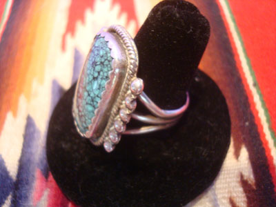 Native American Indian vintage sterling silver jewelry, and Navajo sterling silver jewelry, a stunning Navajo sterling silver ring with beautiful spider-web turquoise and fine silverwork, Arizona or New Mexico, c. 1950. The turquoise is exceptional, and the ring has braiding around the bezzle and six sterling spheres on each side of the stone. A side view of the ring.