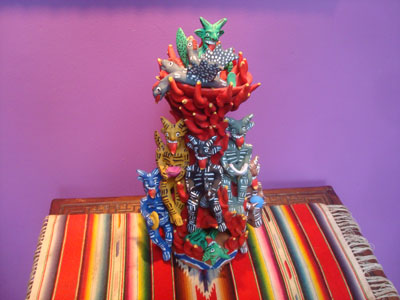 Mexican vintage folk art, and Mexican vintage pottery and ceramics, a beautiful pottery sculpture of a burning tower of devils delighted by the tasty fowl being roasted in a bowl on the top, Ocumicho, Michoacan, c. 1950.