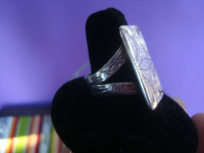 Native American Indian sterling silver jewelry, and Navajo vintage sterling silver jewelry, a wonderful sterling silver ring with fine stamping on the front and sides, Arizona or New Mexico, c. 1950's. The ring has a beautiful design, and it is very elegant. A side view of the ring.